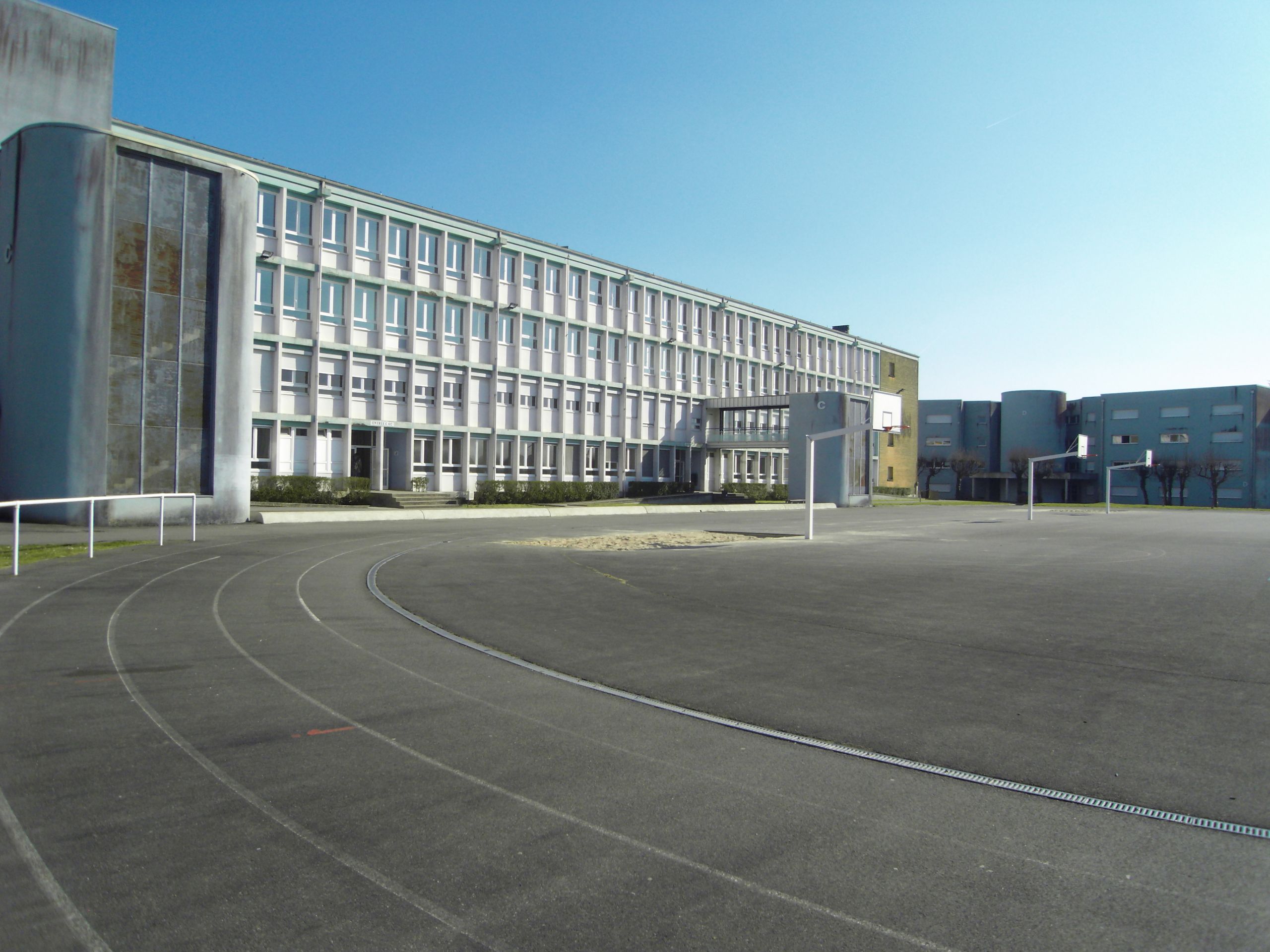 View of School s running track and one of the teaching buildings JPG