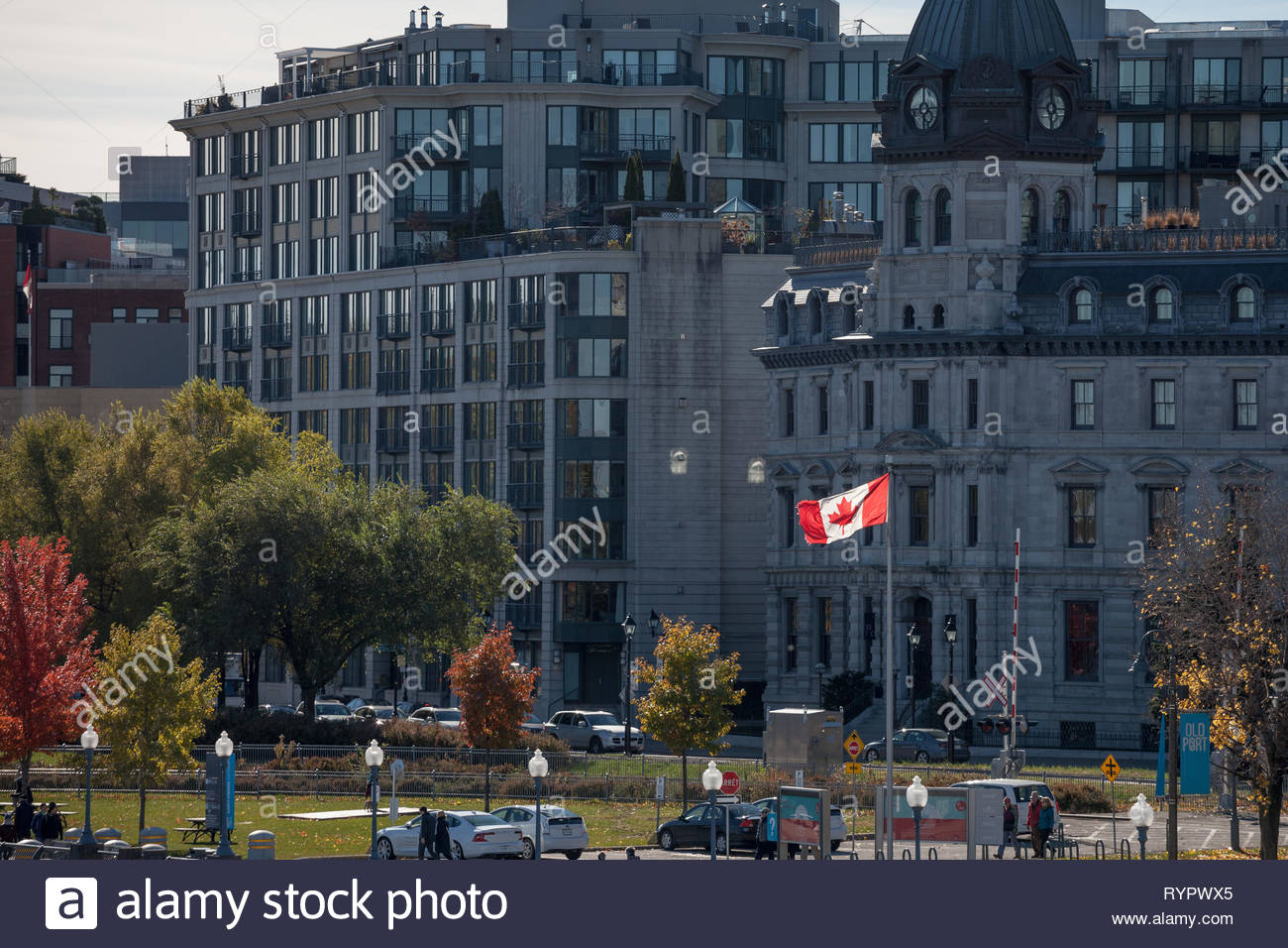 montreal canada november 4 2018 canadian flag waiving on the waterfront of old montreal with pedestrians passing by old montreal or vieux montr RYPWX5