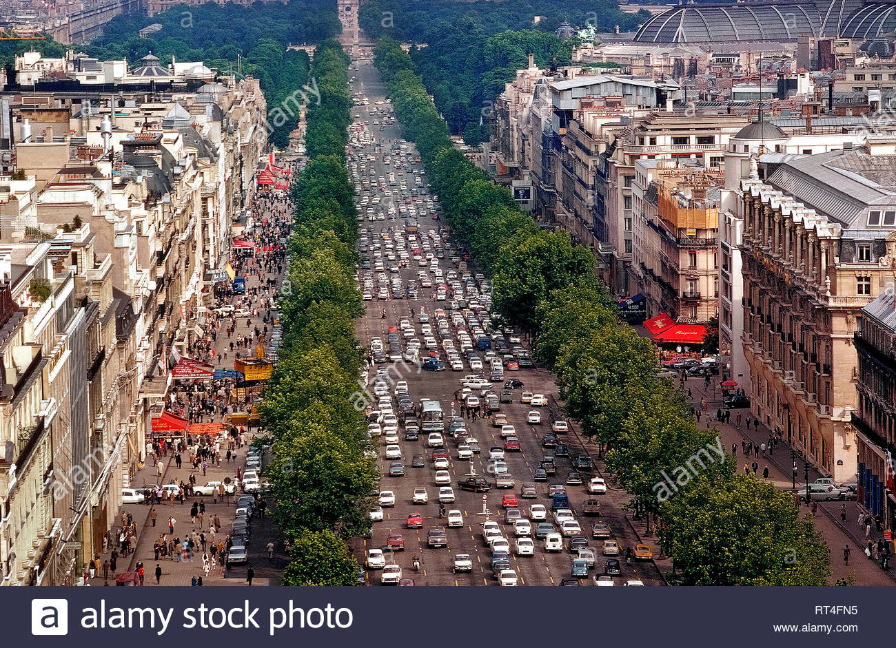 an aerial view shows the beautiful tree lined champs lyses one of the busiest and most congested avenues in all of paris france the famous 12 mile long 19 km thoroughfare runs between two of the french capitals monumental landmarks the place de la concorde and arc de triomphe since this photograph was taken in 1983 the 11 lanes of traffic have been reduced to eight and there are plans to reduce vehicle use even more in order widen the sidewalks and make the street more pedestrian friendly by the mid 2020s RT4FN5