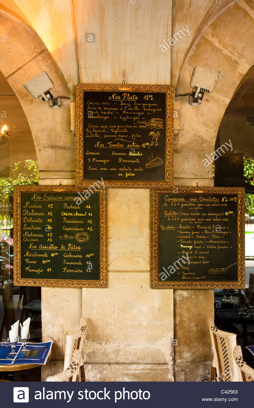 restaurant menu boards at the place des vosges in paris C