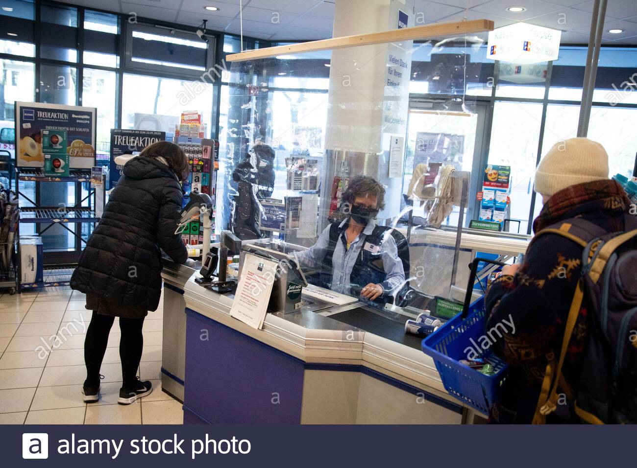 hamburg germany 23rd mar 2020 temporary protective measures protect cashiers in a branch of the budni store chain in many branches of aldi lidl netto rewe penny and other supermarkets and stores plexiglas panes and other devices are currently installed as spit protection at the cash registers according to a survey of supermarket and discount store chains by the german press agency in order to slow down the spread of the corona virus the federal government has further considerably restricted public life the novel coronavirus is mainly transmitted by droplet infection ph 2B