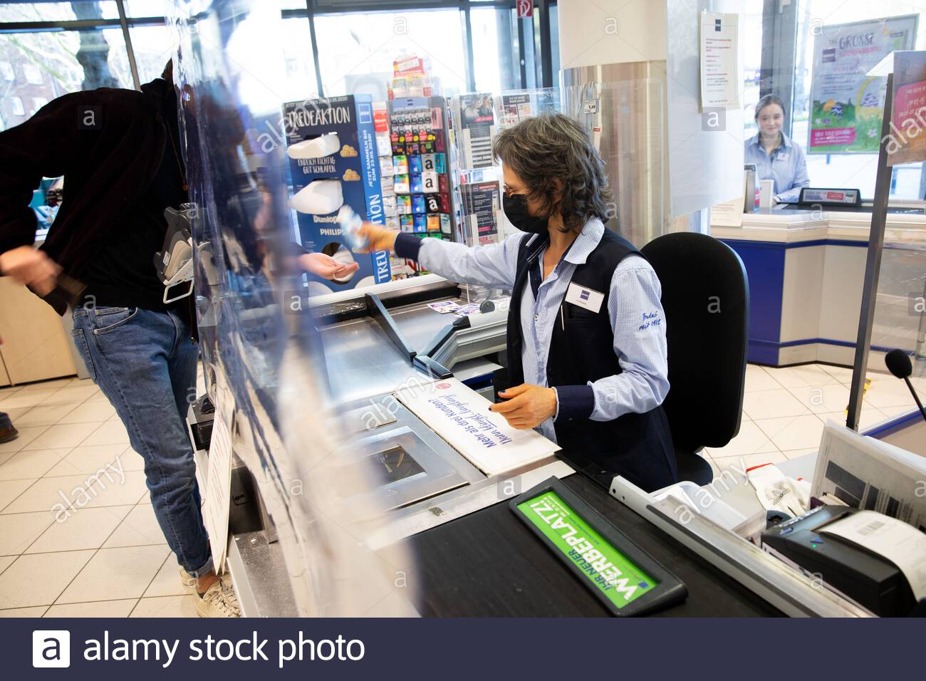 hamburg germany 23rd mar 2020 temporary protective measures protect cashiers in a branch of the budni store chain in many branches of aldi lidl netto rewe penny and other supermarkets and stores plexiglas panes and other devices are currently installed as spit protection at the cash registers according to a survey of supermarket and discount store chains by the german press agency in order to slow down the spread of the corona virus the federal government has further considerably restricted public life the novel coronavirus is mainly transmitted by droplet infection ph 2B9332P